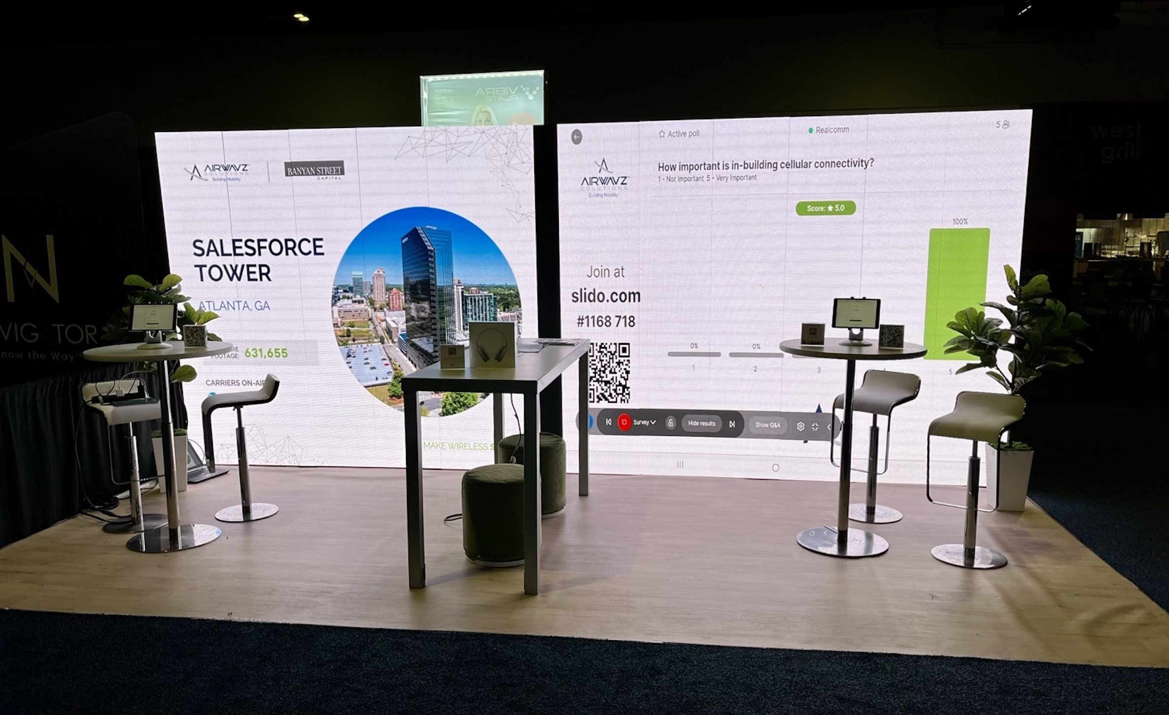 Trade show booth in Chicago featuring a high-resolution LED screen displaying Salesforce Tower visuals and interactive poll results with modern furnishings.